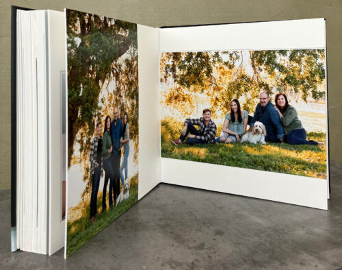 matted photo album open to outdoor family photos